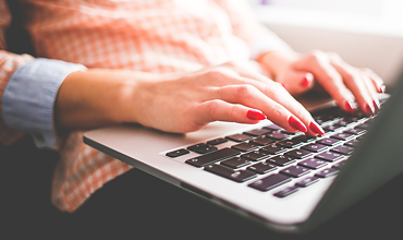 Woman types something on her notebook